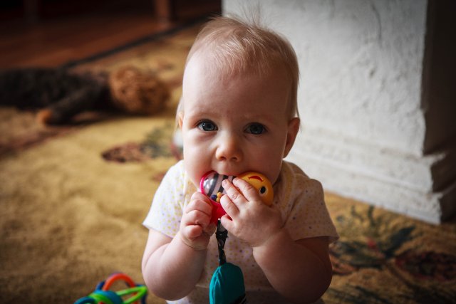Sonja eating her toys